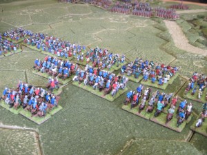 Celtic warrior hordes followed by Gaul heavy cavalry advance to the edge of the river and the Roman left flank.